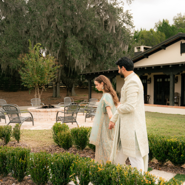 la hacienda snow hill couple traditional attire garden walkway spanish venue