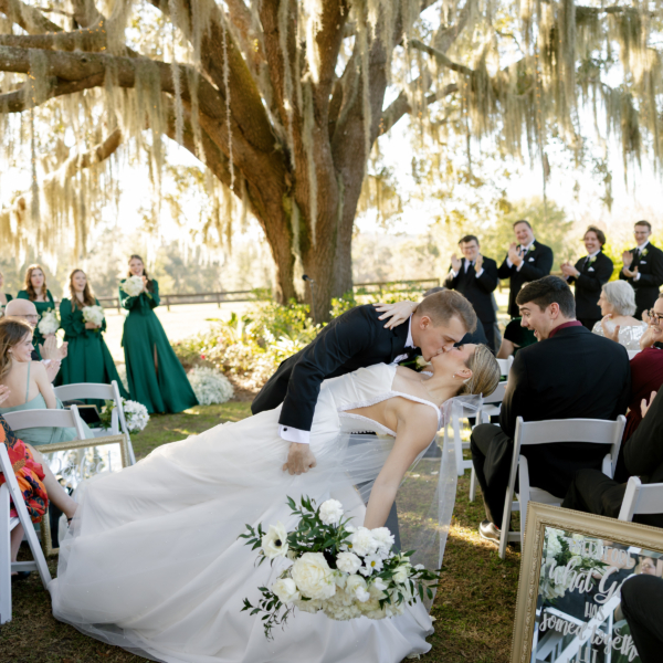 la hacienda snow hill outdoor wedding ceremony first kiss spanish moss oak tree