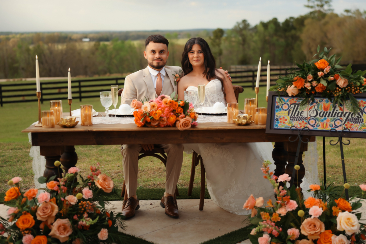 la hacienda snow hill outdoor wedding reception sweetheart table orange florals