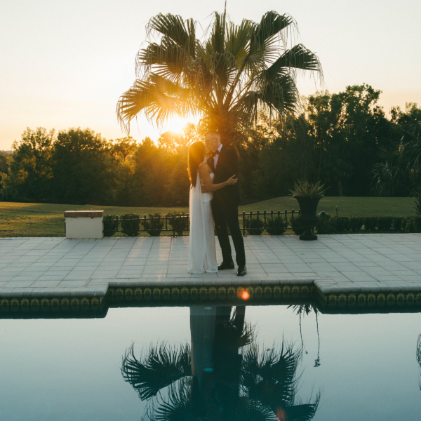 la hacienda snow hill romantic sunset wedding couple poolside palm tree reflection