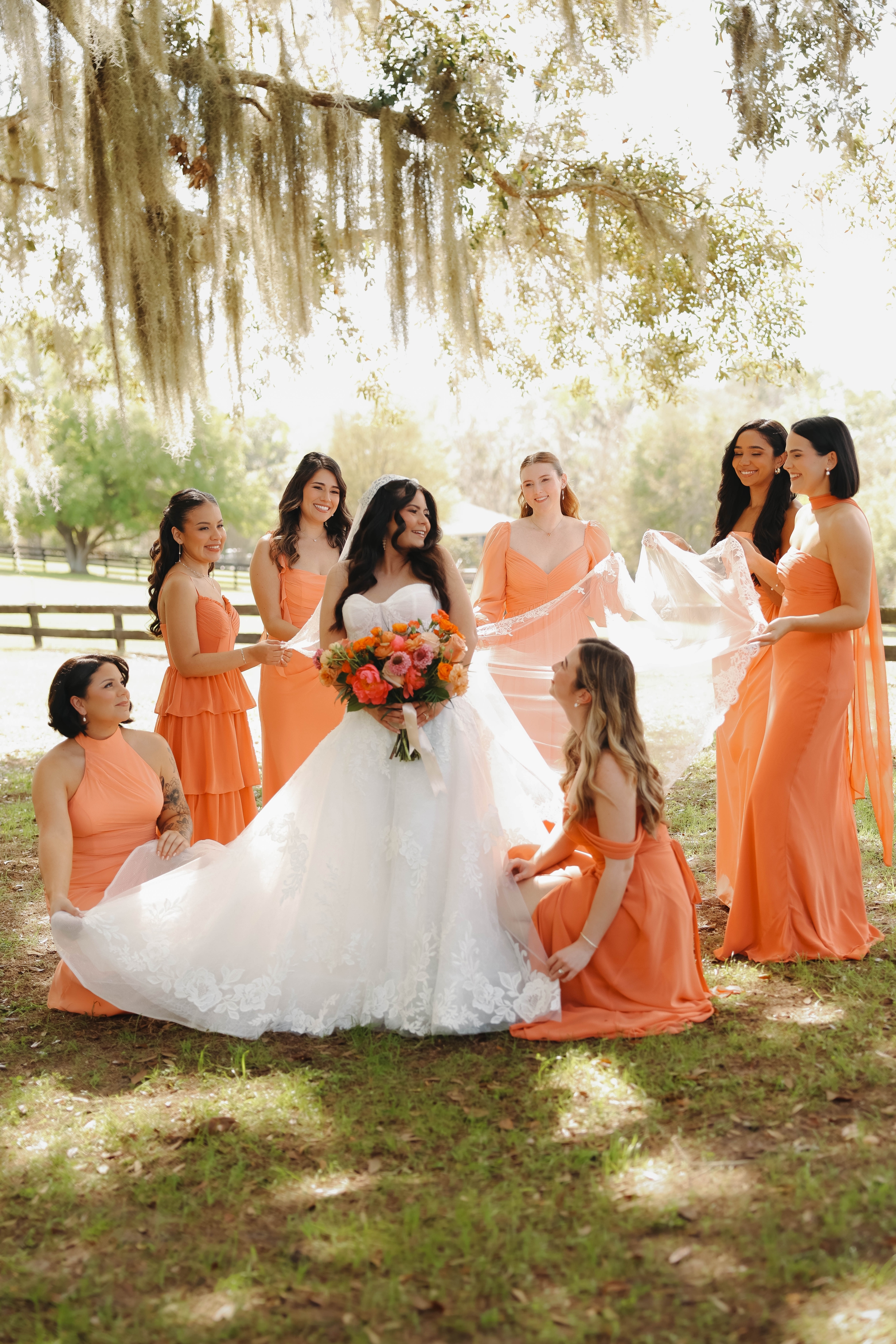 la hacienda snow hill spring colors bride with bridesmaids fluffing dress - Vibrant Spring Weddings: The Must See Trend at La Hacienda On Snow Hill la hacienda snow hill spring colors bride with bridesmaids fluffing dress