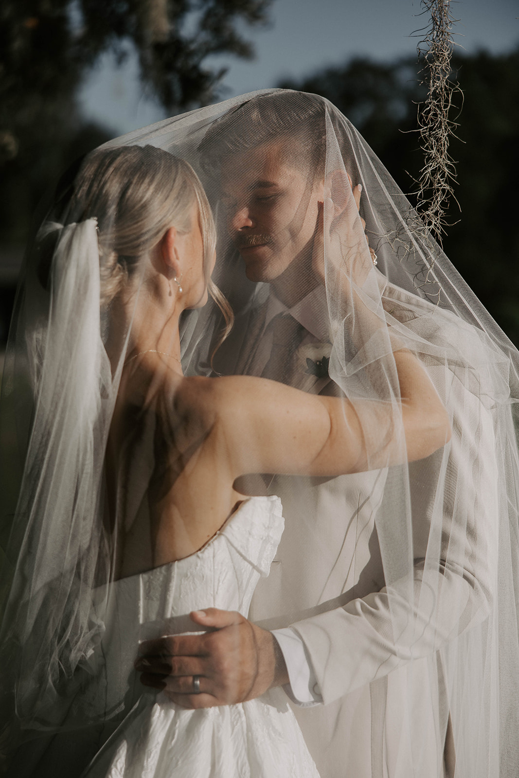 bride groom veil portrait la hacienda brooksville florida - A Fall Wedding at La Hacienda on Snow Hill in Brooksville, FL Bride and groom share an intimate moment under her flowing veil at La Hacienda on Snow Hill wedding venue in Brooksville Florida near Tampa